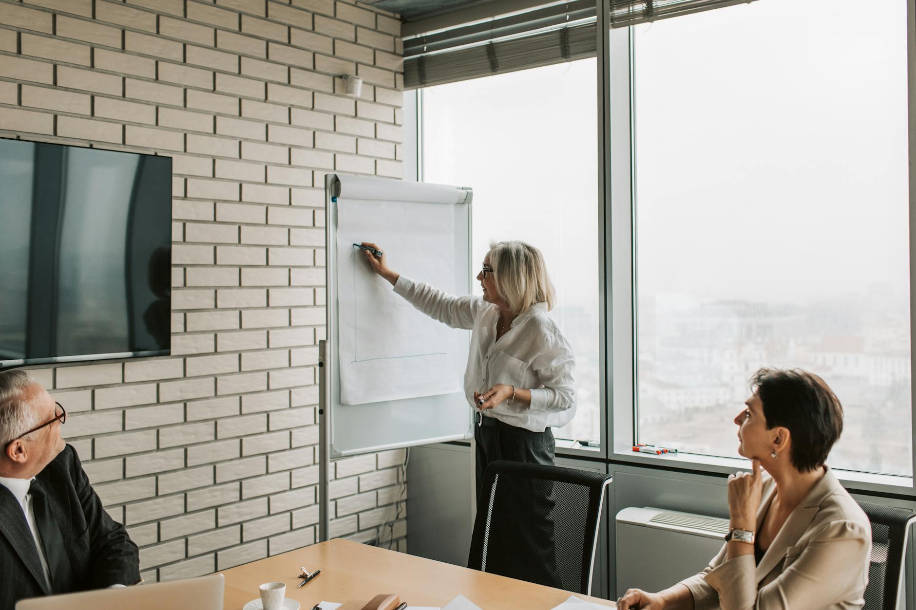 The B2B SEO ROI Framework: Connecting Organic Growth to Pipeline 12 Marketing leader presenting SEO ROI metrics to executives in a boardroom setting