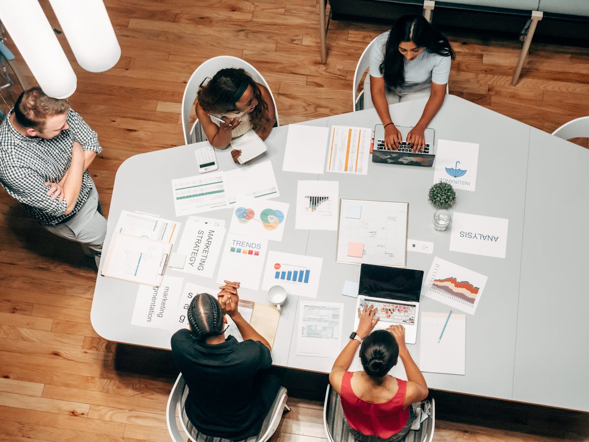 GA4 Audit Checklist: 7 Critical Configuration Errors Killing Your B2B Analytics 18 Team reviewing analytics audit results and implementation roadmap in a business meeting