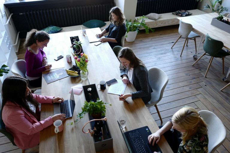 Overhead view of a B2B marketing team collaborating at a shared table on a demand generation strategy