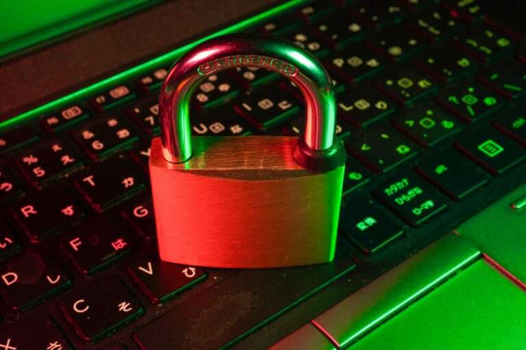 A padlock resting on a backlit keyboard, representing the trust and verification standard cybersecurity buyers hold marketing content to