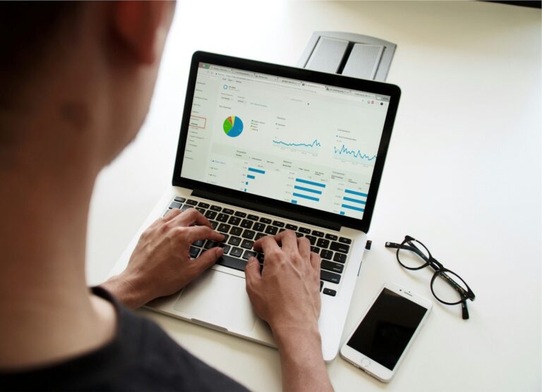 Marketer reviewing a campaign analytics dashboard on a laptop