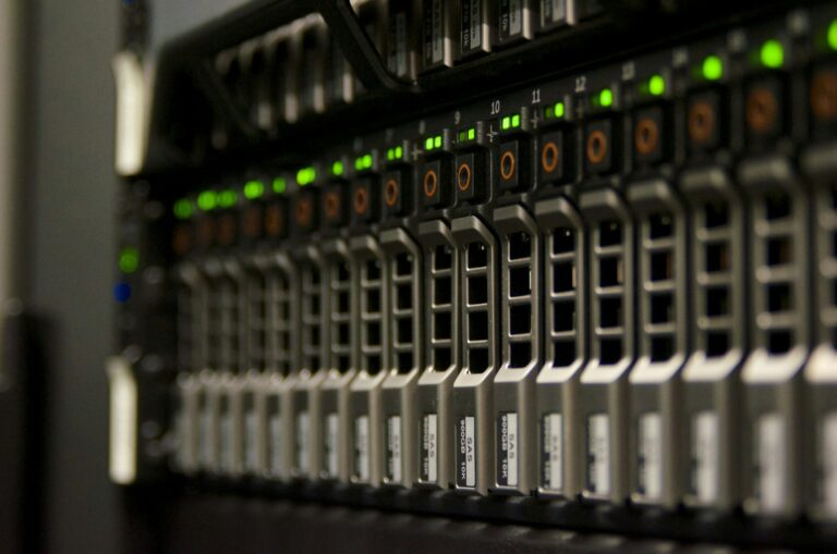 Close-up of a data center server rack with drive bays and green status lights, representing raw server logs used for crawl budget analysis